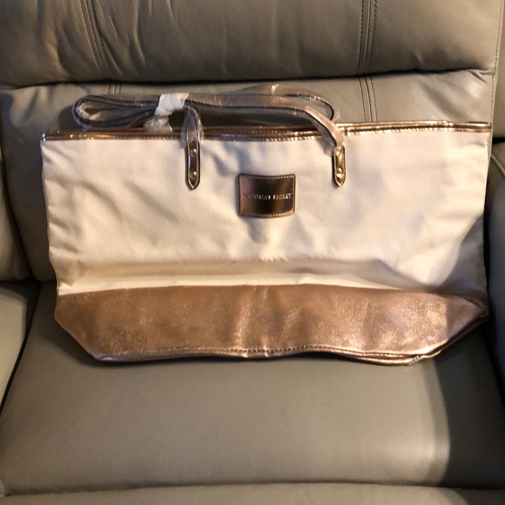 Brand New! In original bag, Victoria Secret taupe satchel with rose gold lining.